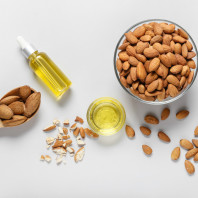 Composition with almond oil on light background