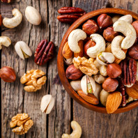 Nuts mixed in a wooden plate choices for charcuterie board