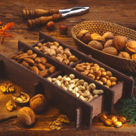 Nuts tray on a wood table. Cinnamon Roasted Almonds